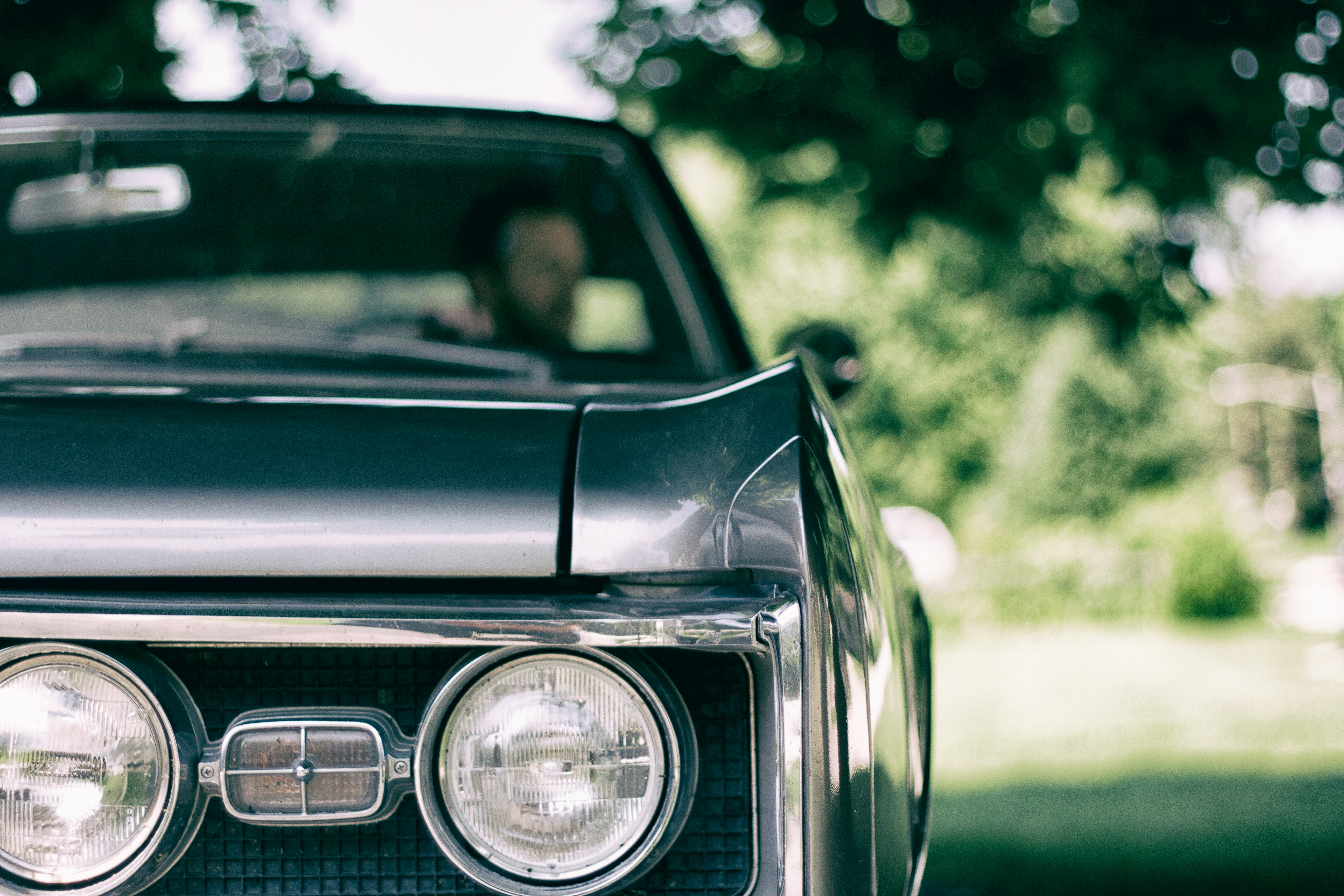 man inside black muscle car